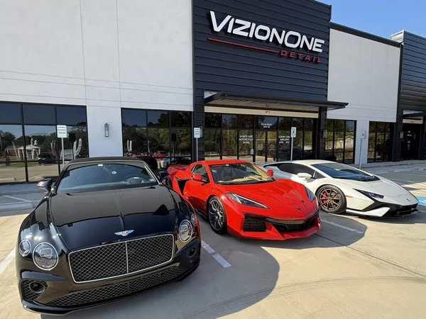 Bentley, Corvette and Lamborghini Huracán parked in front of the shop