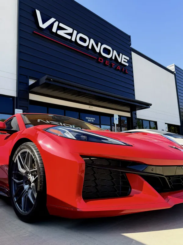 Red Corvette Z06 under the VizionOne sign