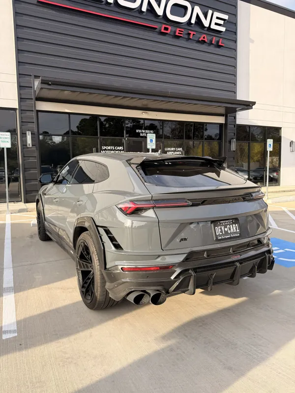 Grey Lamborghini Urus at the storefront