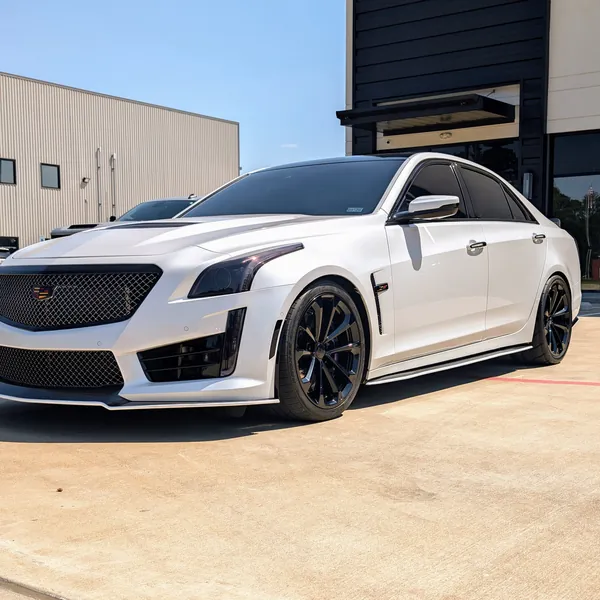 White Cadillac CTS-V outside the building
