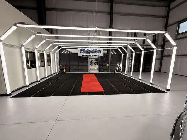 The light tunnel lit up over the black mat and red runner