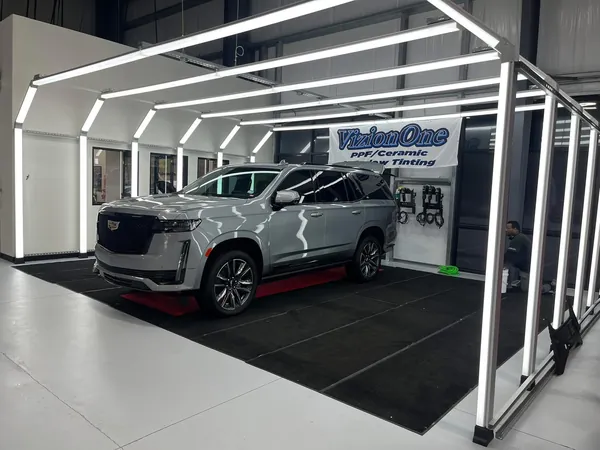 Silver Cadillac Escalade under the light tunnel