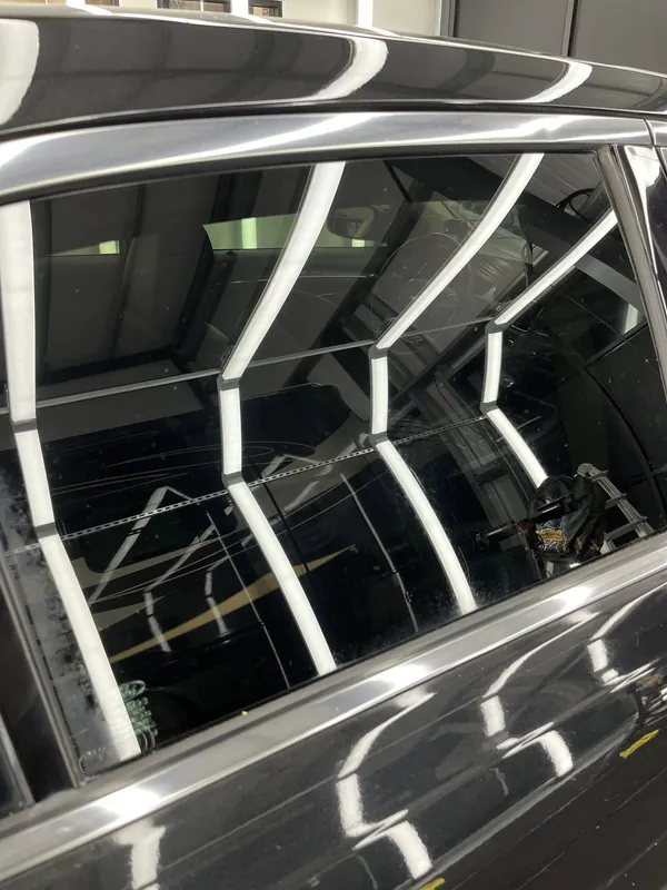 The shop lights reflected in tinted glass