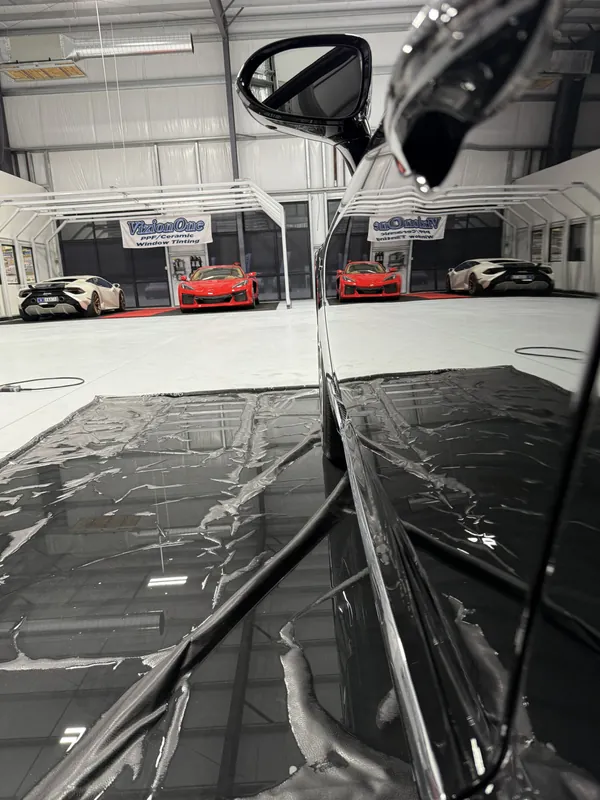 Glossy black hood reflecting the shop
