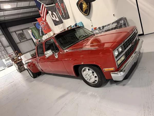 Red Chevy C30 dually in the shop