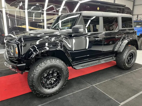 Black Ford Bronco on the red mats