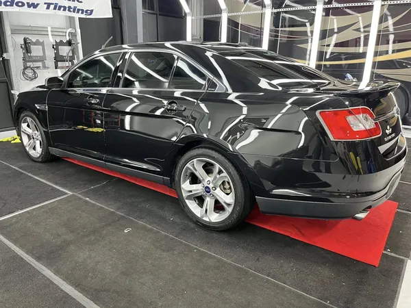 Black sedan in the tint bay