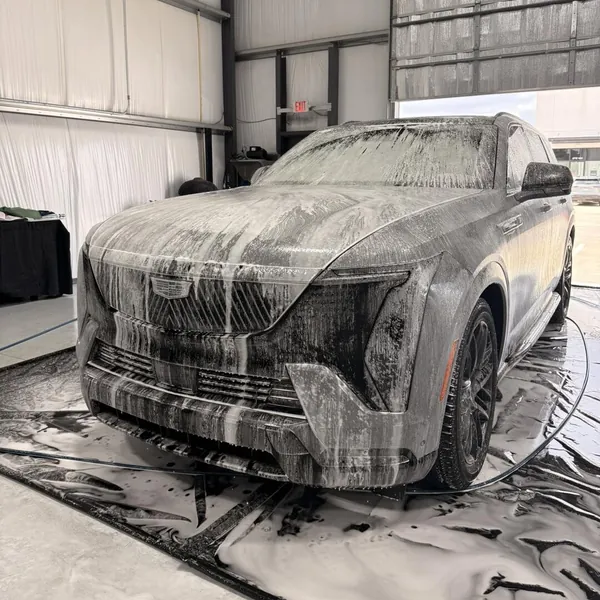 Cadillac covered in foam on the wash mat
