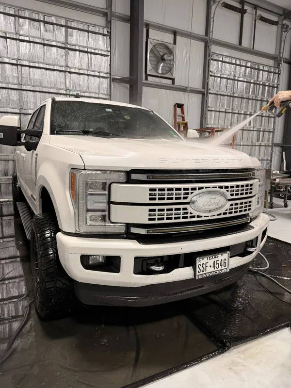 White Ford F-250 being pressure-washed