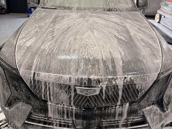 SUV hood covered in foam during the wash